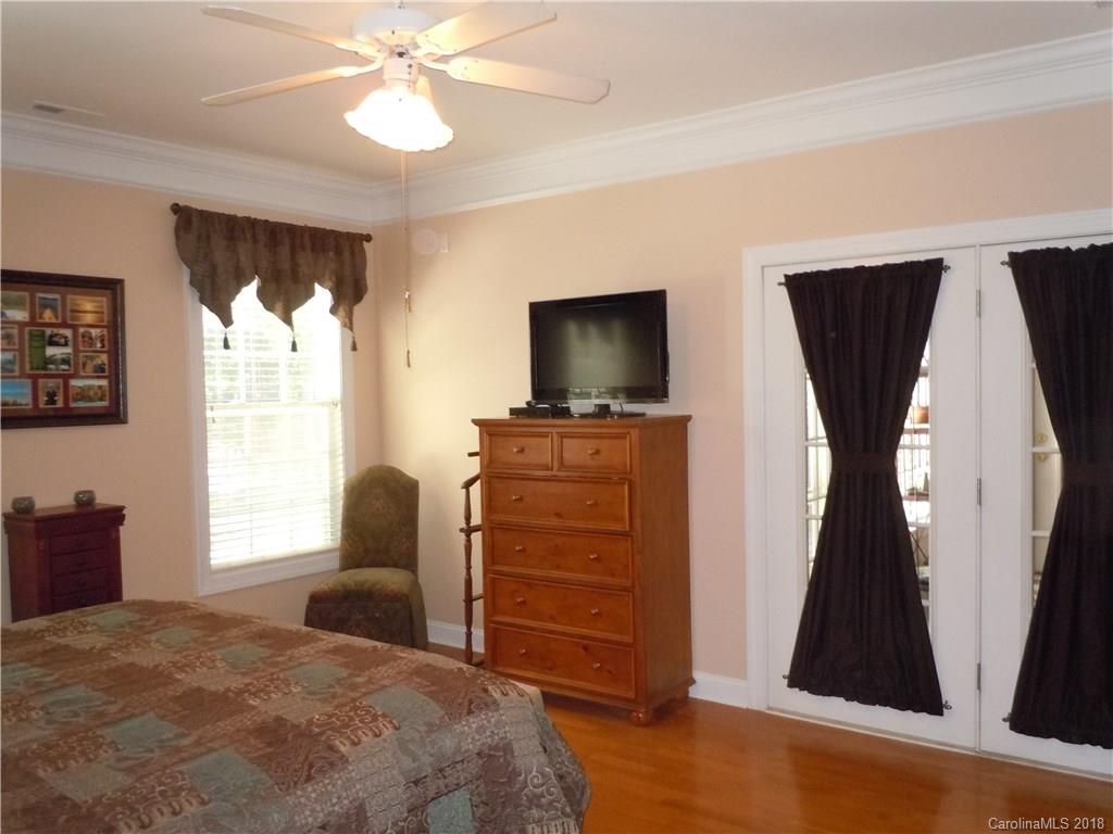 124 Zimmerman Drive Fort Mill, SC 29708 - Photo 22 of 35 a bedroom with a bed and a flat tv screen on dresser