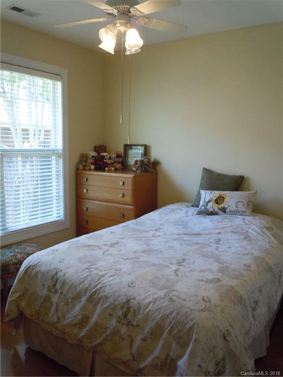 124 Zimmerman Drive Fort Mill, SC 29708 - Photo 28 of 35 a bedroom with a bed and a chandelier