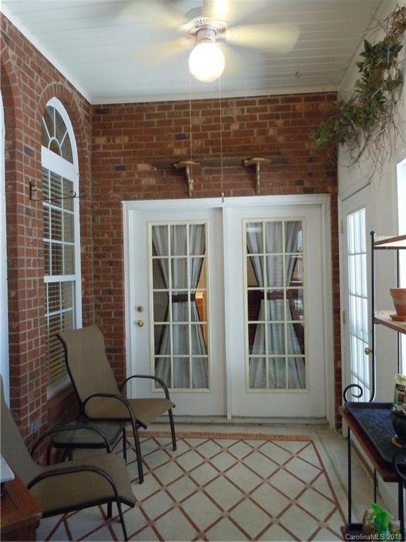 124 Zimmerman Drive Fort Mill, SC 29708 - Photo 30 of 35 a view of a brick house with chairs and table in a patio