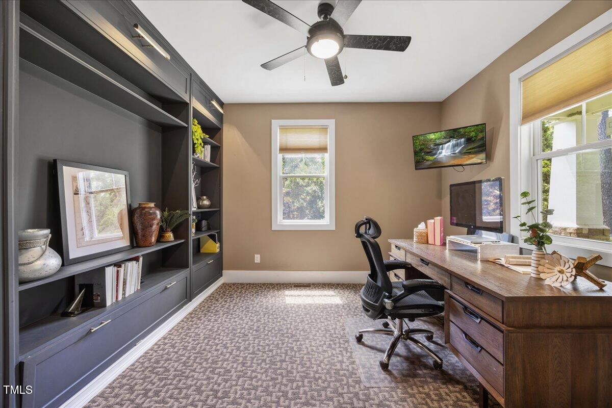 12636 Old Creedmoor Road Raleigh, NC 27613 - Photo 5 of 45 a view of a workspace with furniture and a window