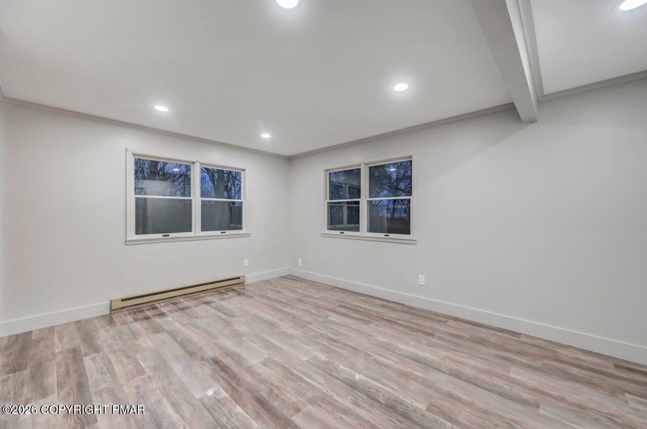 384 Devils Hole Road Cresco, PA 18326 - Photo 66 of 97 a view of empty room with wooden floor and fan