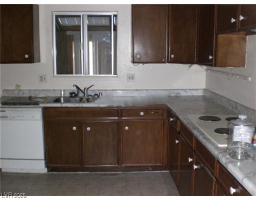 332 Huntly Road Las Vegas, NV 89145 - Photo 3 of 7 Kitchen with dark brown cabinetry, white appliance