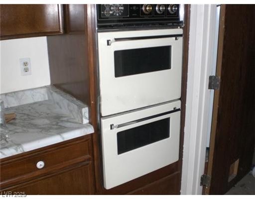 332 Huntly Road Las Vegas, NV 89145 - Photo 4 of 7 Kitchen featuring double oven and dark brown cabin