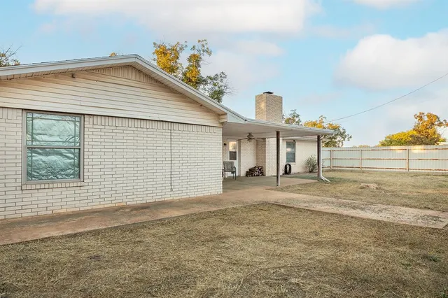 a view of a house with a yard and garage