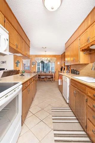 a kitchen with stainless steel appliances kitchen island granite countertop a sink and cabinets