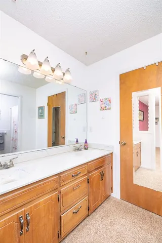 a spacious bathroom with a double vanity sink and a mirror