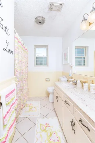 a spacious bathroom with a sink a toilet and a bathtub