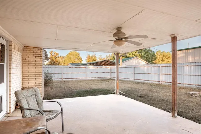 a bedroom with a bed and large window
