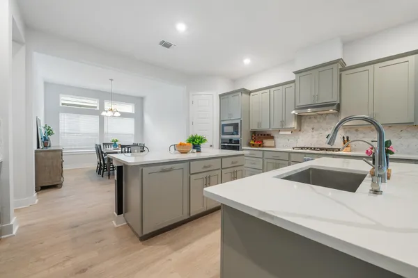 a kitchen with a sink cabinets and window
