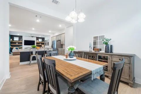 a view of a dining room with furniture and a kitchen