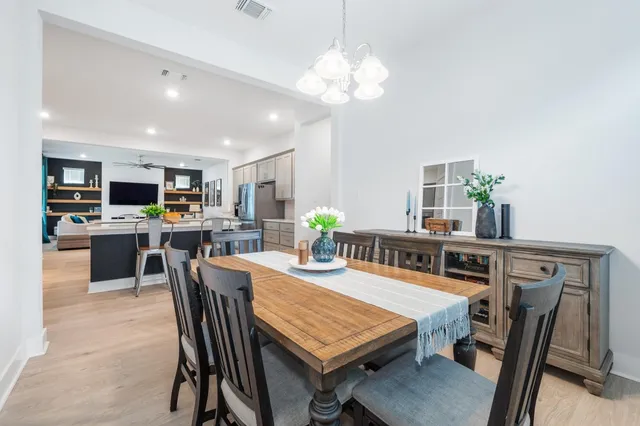 a view of a dining room with furniture and a kitchen