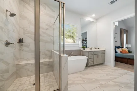 a bathroom with a double vanity sink a mirror and a bathtub