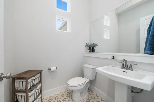 a bathroom with a sink toilet and a mirror