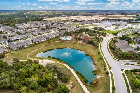 an aerial view of residential houses with outdoor space