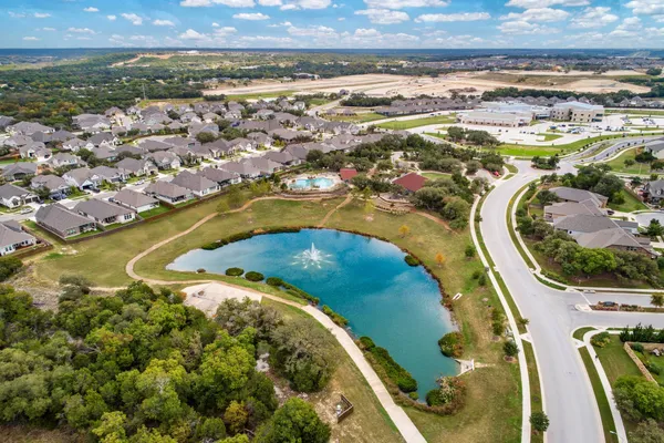 an aerial view of residential houses with outdoor space