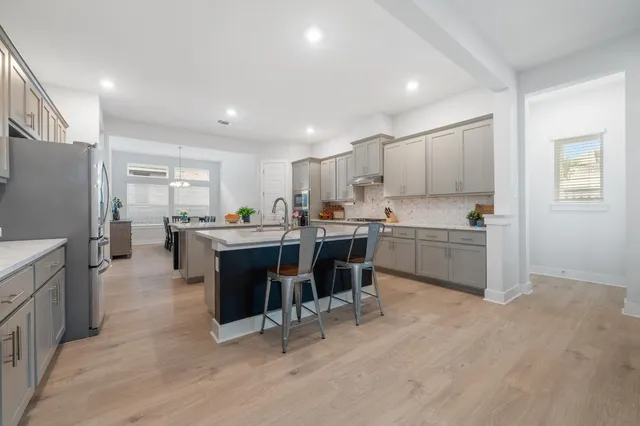 a kitchen with a sink a counter top space and stainless steel appliances
