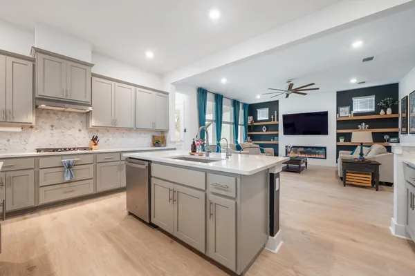 a kitchen with stainless steel appliances granite countertop a lot of counter space and a sink