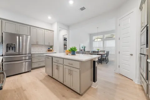 a kitchen with stainless steel appliances a sink and a refrigerator