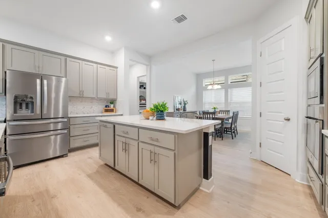 a kitchen with stainless steel appliances a sink and a refrigerator