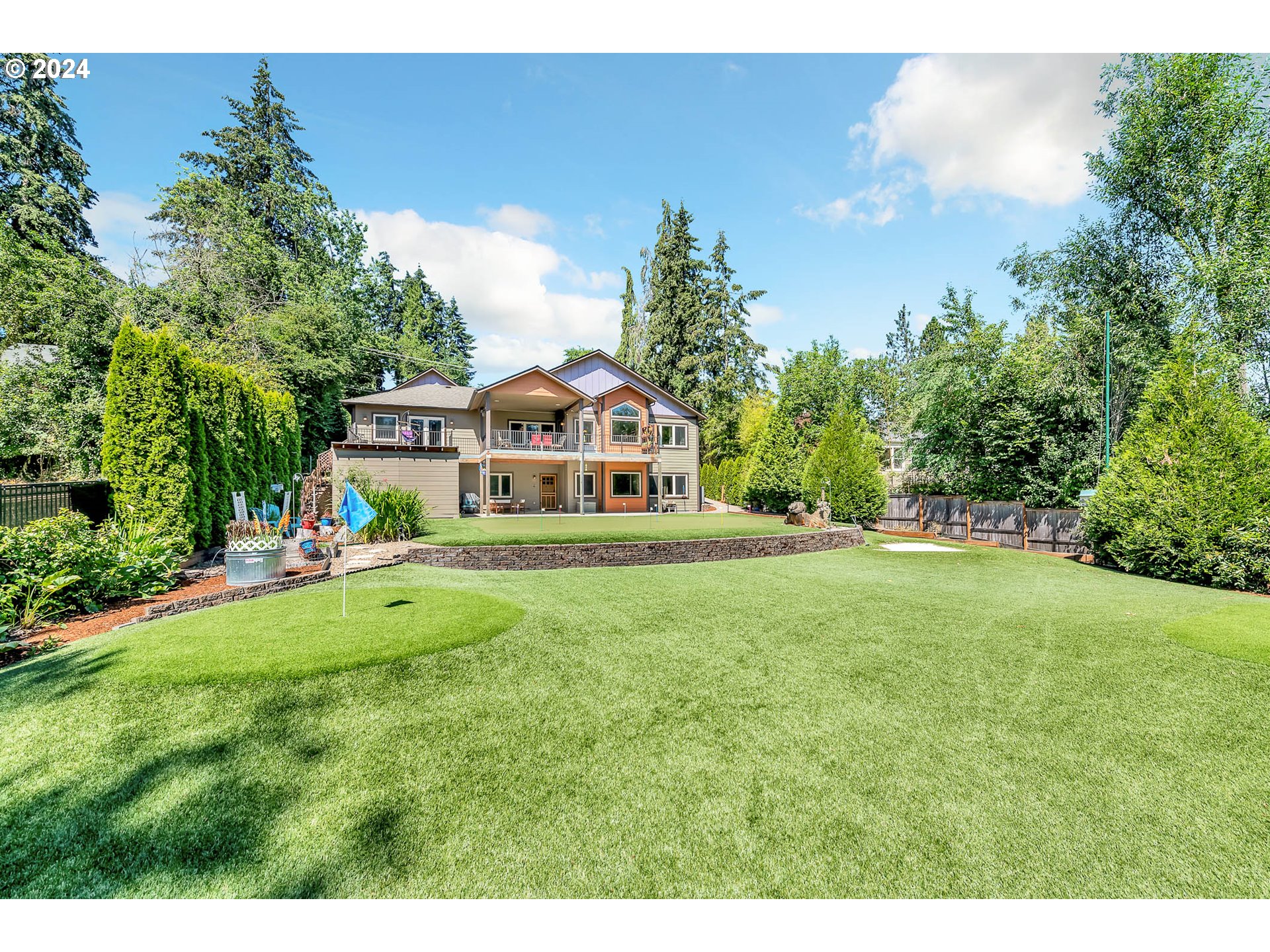 2735 Emerald Street Eugene, OR 97403 - Photo 36 of 47 a white house with a big yard and large trees