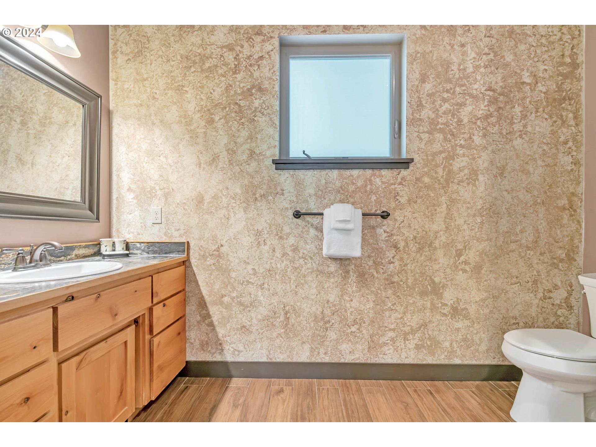 2735 Emerald Street Eugene, OR 97403 - Photo 43 of 47 a bathroom with a toilet a sink a mirror and a window