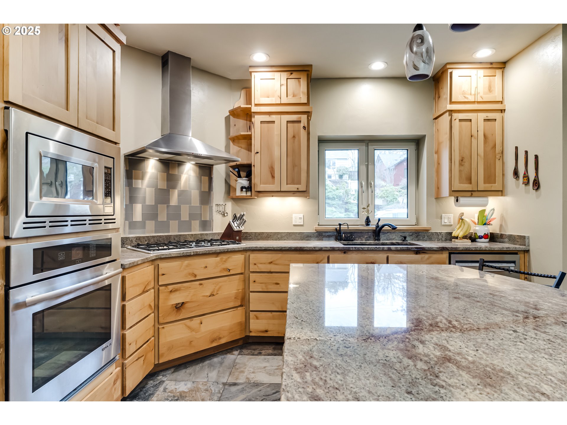 2735 Emerald Street Eugene, OR 97403 - Photo 8 of 47 a kitchen with stainless steel appliances granite countertop a sink a stove and cabinets