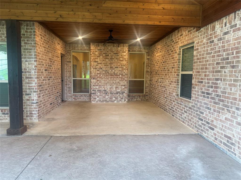 101 Bedding Lane Azle, TX 76020 - Photo 4 of 6 Covered patio featuring a wood-plank ceiling with exposed beams, brick exterior walls, recessed lighting, and a ceiling fan