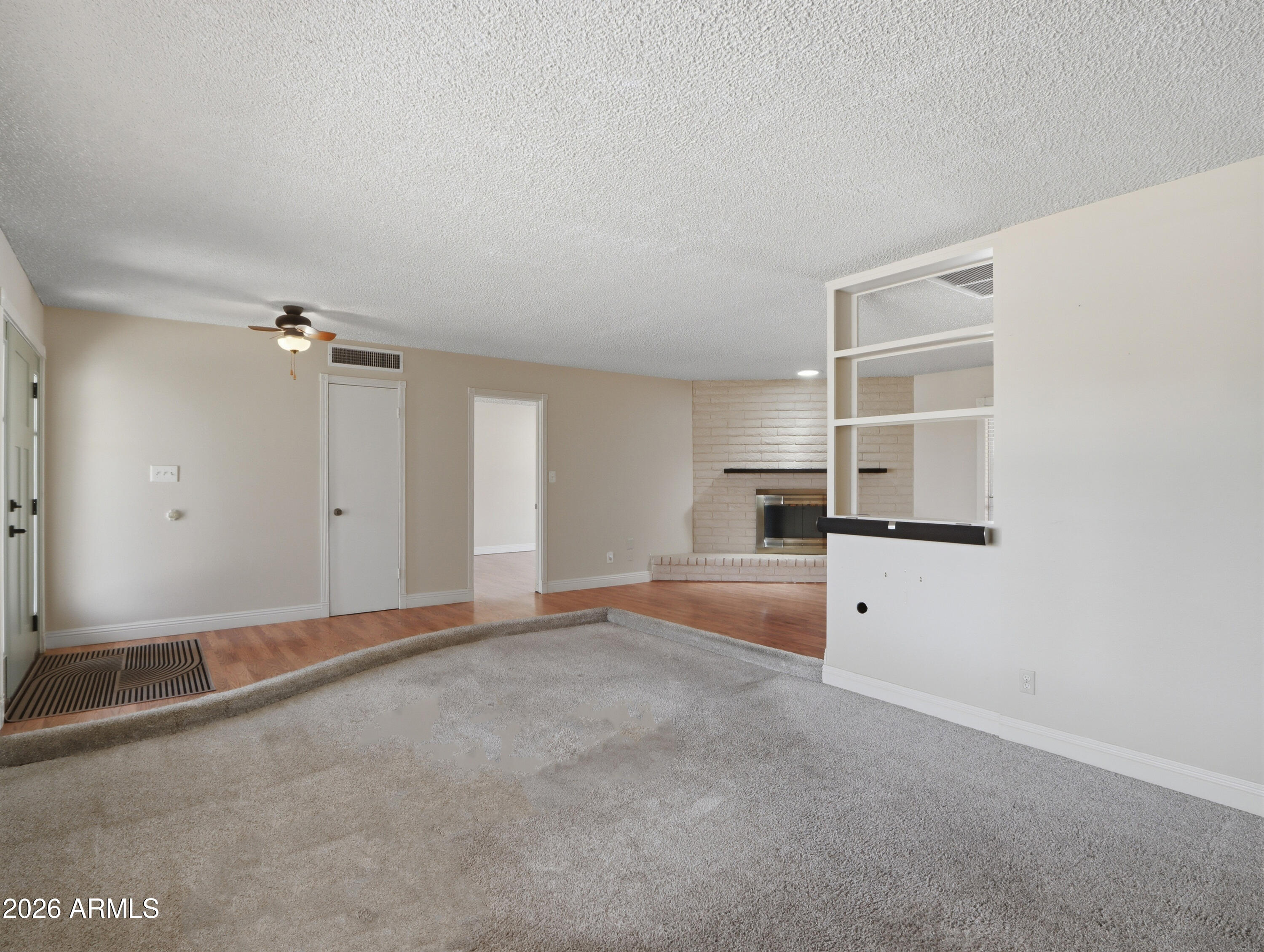 450 Cascada Road Litchfield Park, AZ 85340 - Photo 9 of 40 an empty room with ceiling fan and window