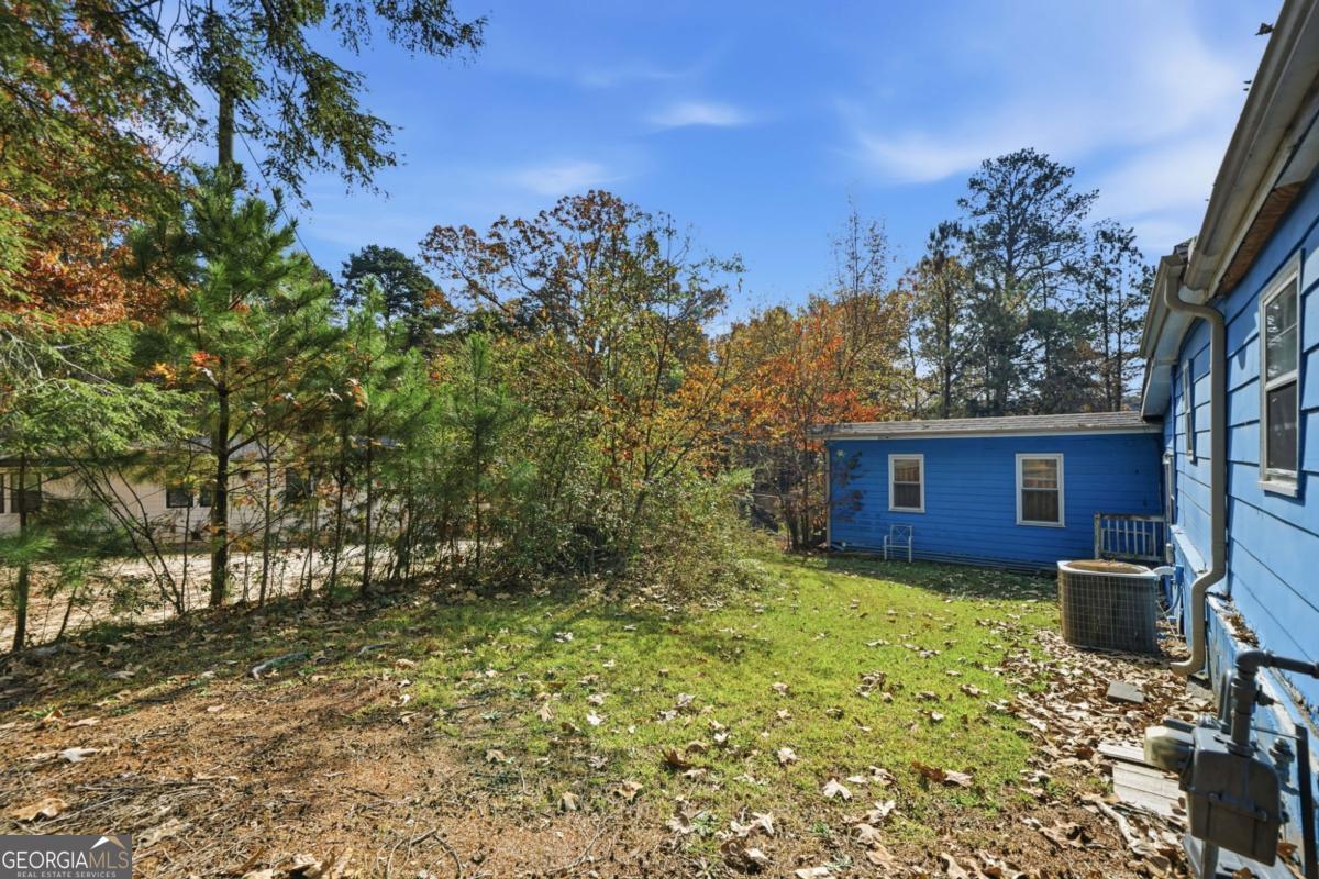 7417 Pleasant Hill Road Lithonia, GA 30058 - Photo 2 of 52 a view of a house with a yard