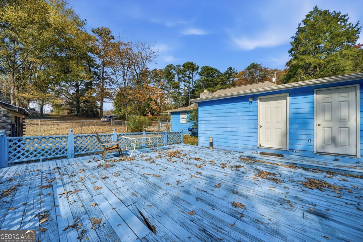 7417 Pleasant Hill Road Lithonia, GA 30058 - Photo 42 of 52 a view of a house with a yard