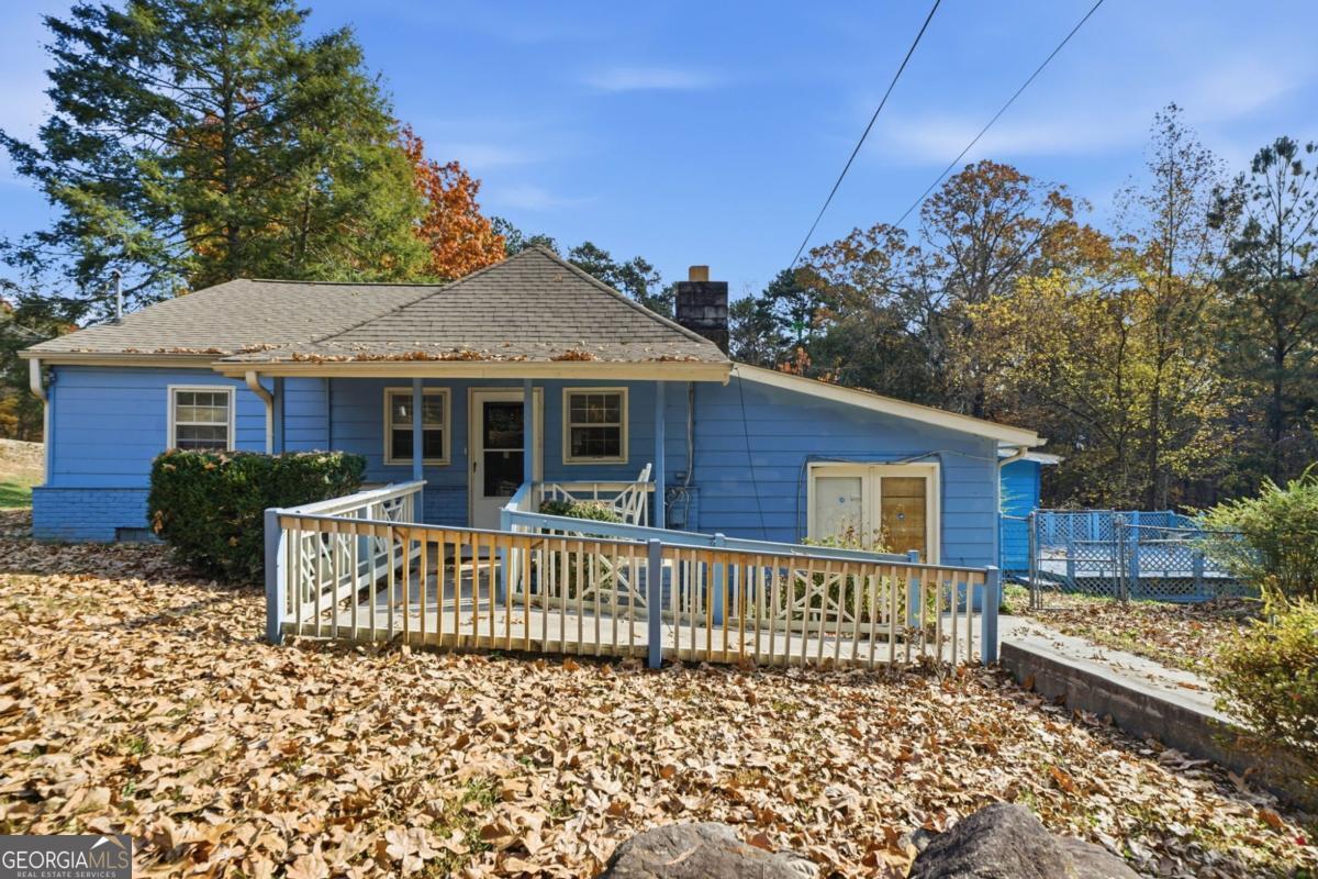 7417 Pleasant Hill Road Lithonia, GA 30058 - Photo 44 of 52 a front view of a house with a garden