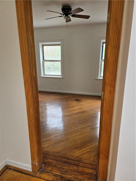 1202 East 38th Street Brooklyn, NY 11210 - Photo 4 of 11 a view of an empty room with wooden floor and a window