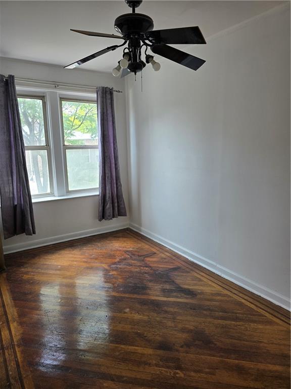 1202 East 38th Street Brooklyn, NY 11210 - Photo 5 of 11 a view of an empty room with wooden floor and a window