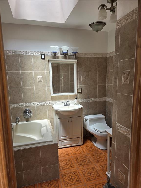 1202 East 38th Street Brooklyn, NY 11210 - Photo 7 of 11 a bathroom with a sink a toilet and shower
