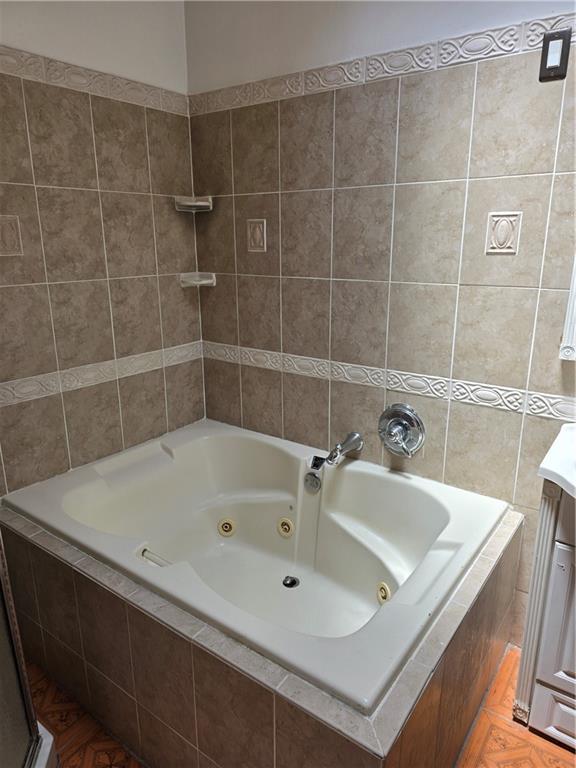 1202 East 38th Street Brooklyn, NY 11210 - Photo 8 of 11 a bathroom with a bathtub