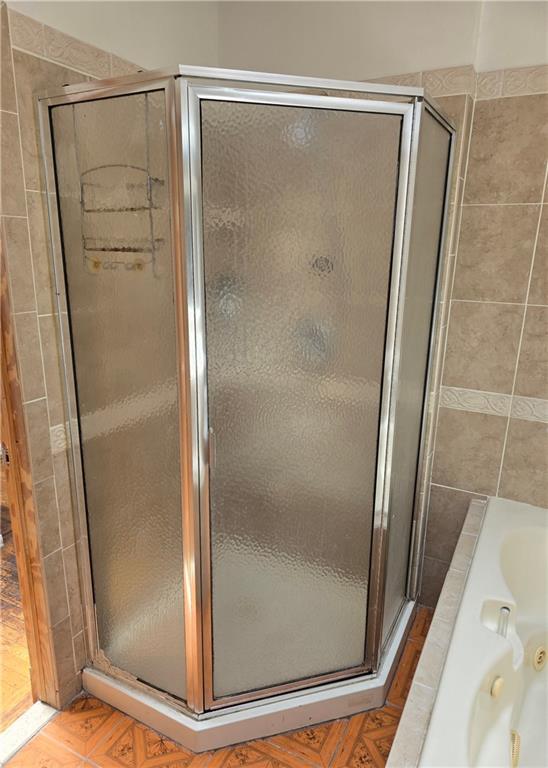 1202 East 38th Street Brooklyn, NY 11210 - Photo 9 of 11 a bathroom with a glass shower door