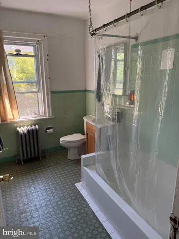 a bathroom with a tub and a shower