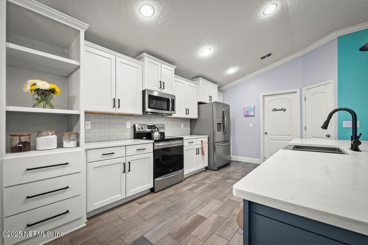 945 Rustlewood Lane St. Johns, FL 32259 - Photo 13 of 43 a kitchen with a sink appliances and cabinets