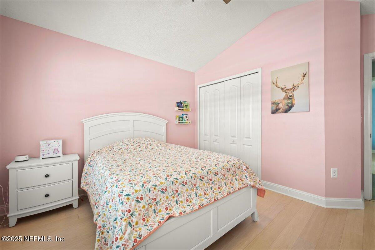945 Rustlewood Lane St. Johns, FL 32259 - Photo 23 of 43 a bedroom with a bed and a night stand
