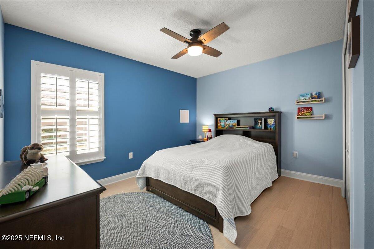 945 Rustlewood Lane St. Johns, FL 32259 - Photo 25 of 43 a bedroom with a bed and window