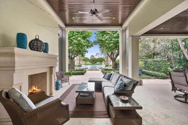 a view of backyard with swimming pool and sitting area