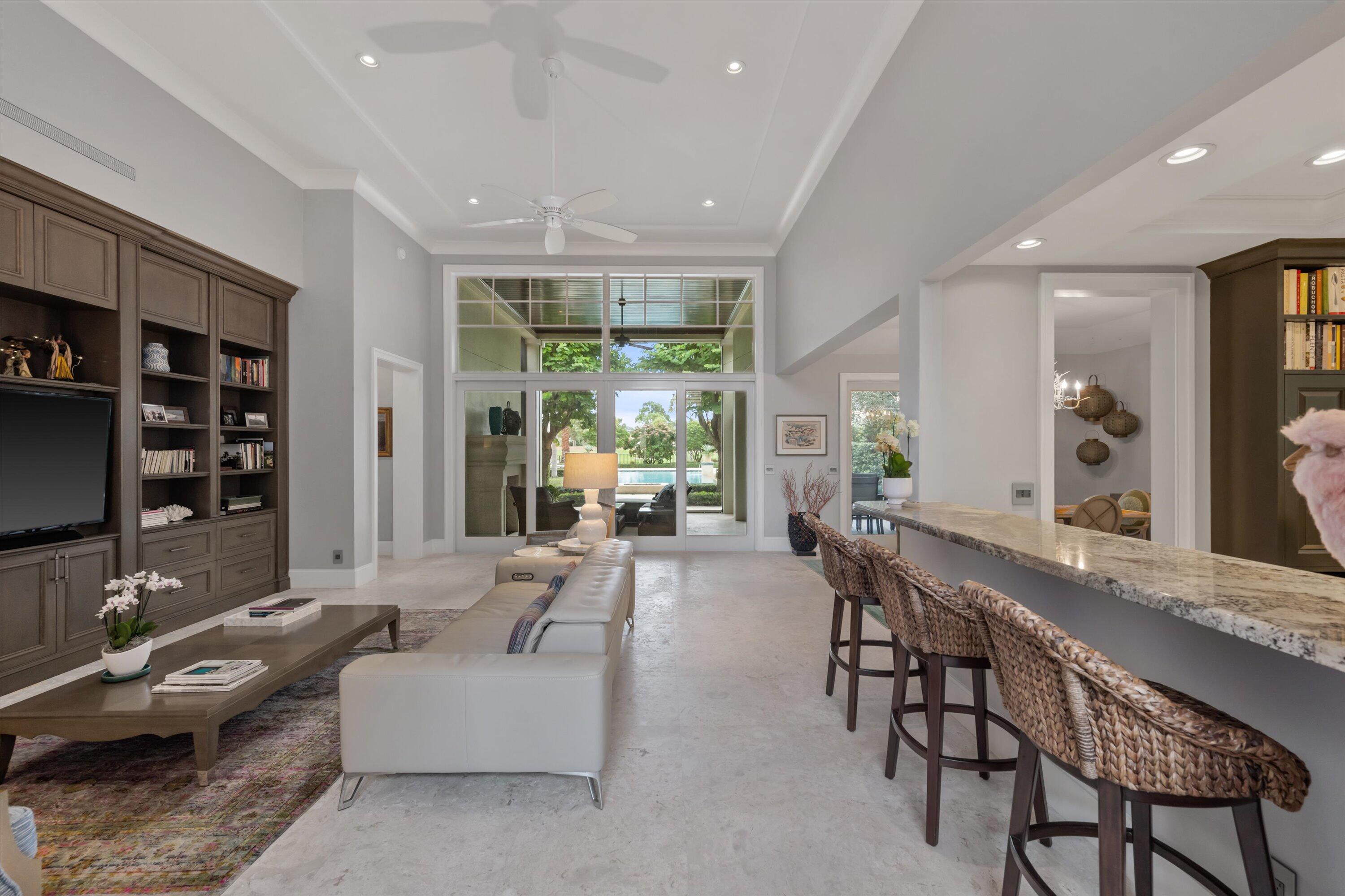 113 Echo Drive Jupiter, FL 33458 - Photo 4 of 15 a living room with furniture a flat screen tv and a large window
