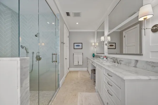 a bathroom with a granite countertop sink a mirror and a bathtub