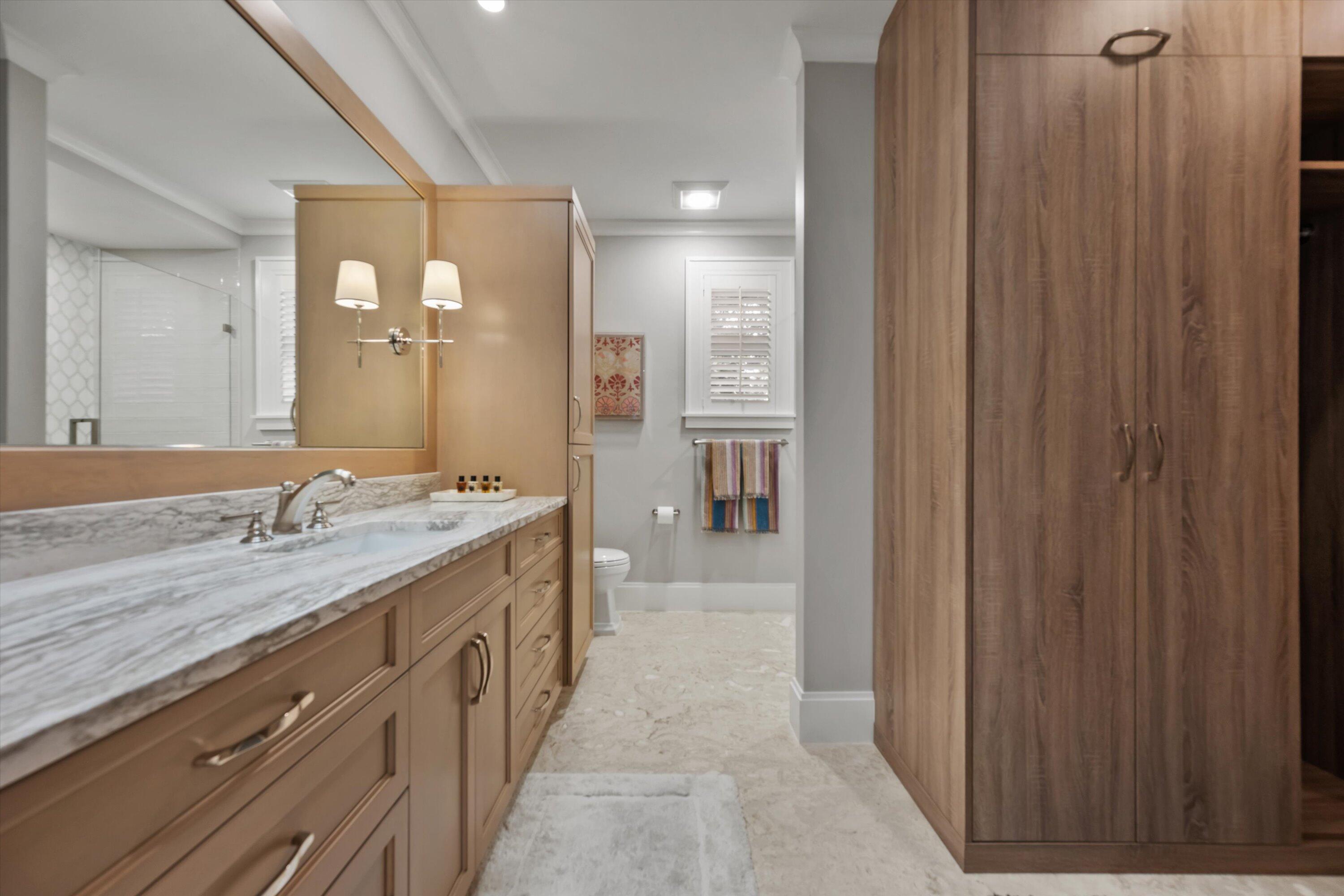 113 Echo Drive Jupiter, FL 33458 - Photo 9 of 15 a bathroom with a granite countertop sink a mirror and a bathtub