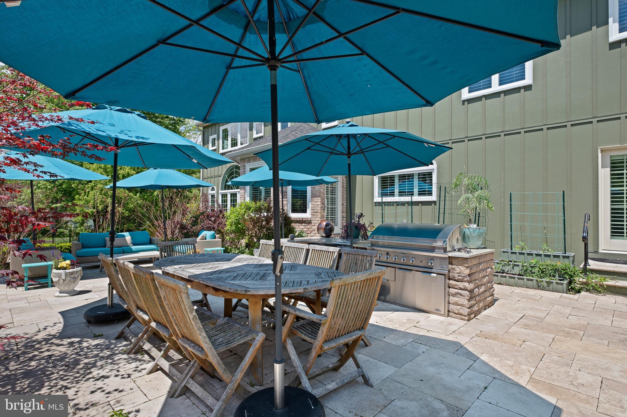 104 Indian Springs Road Kennett Square, PA 19348 - Photo 104 of 106 a view of a patio with chairs and table under an umbrella