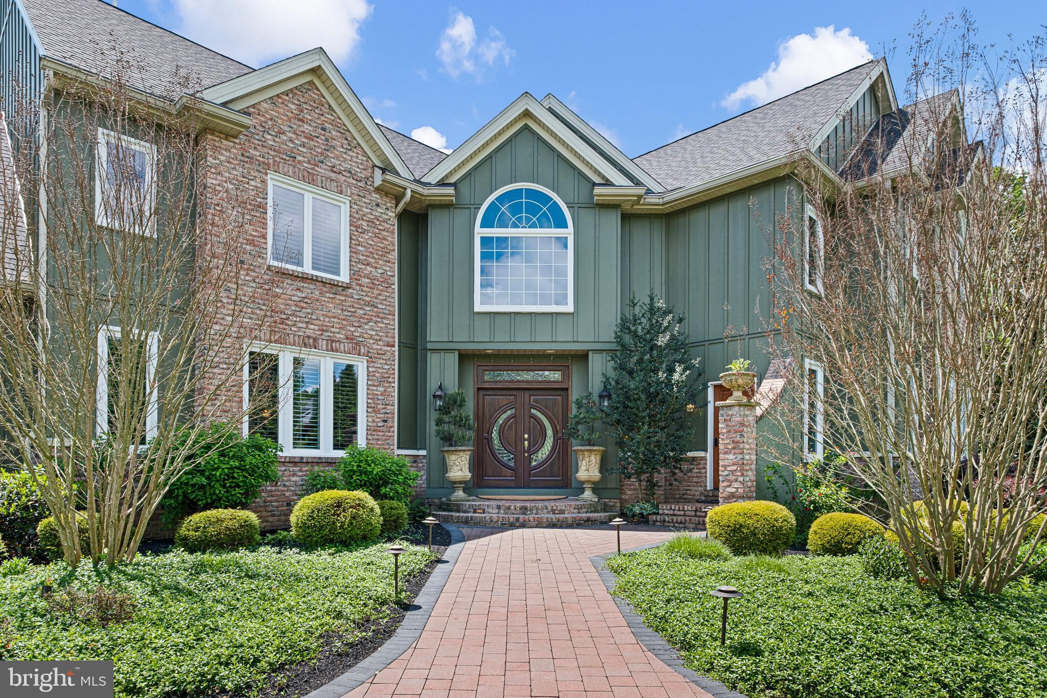 104 Indian Springs Road Kennett Square, PA 19348 - Photo 106 of 106 a view of a brick house with a clock tower in front of it