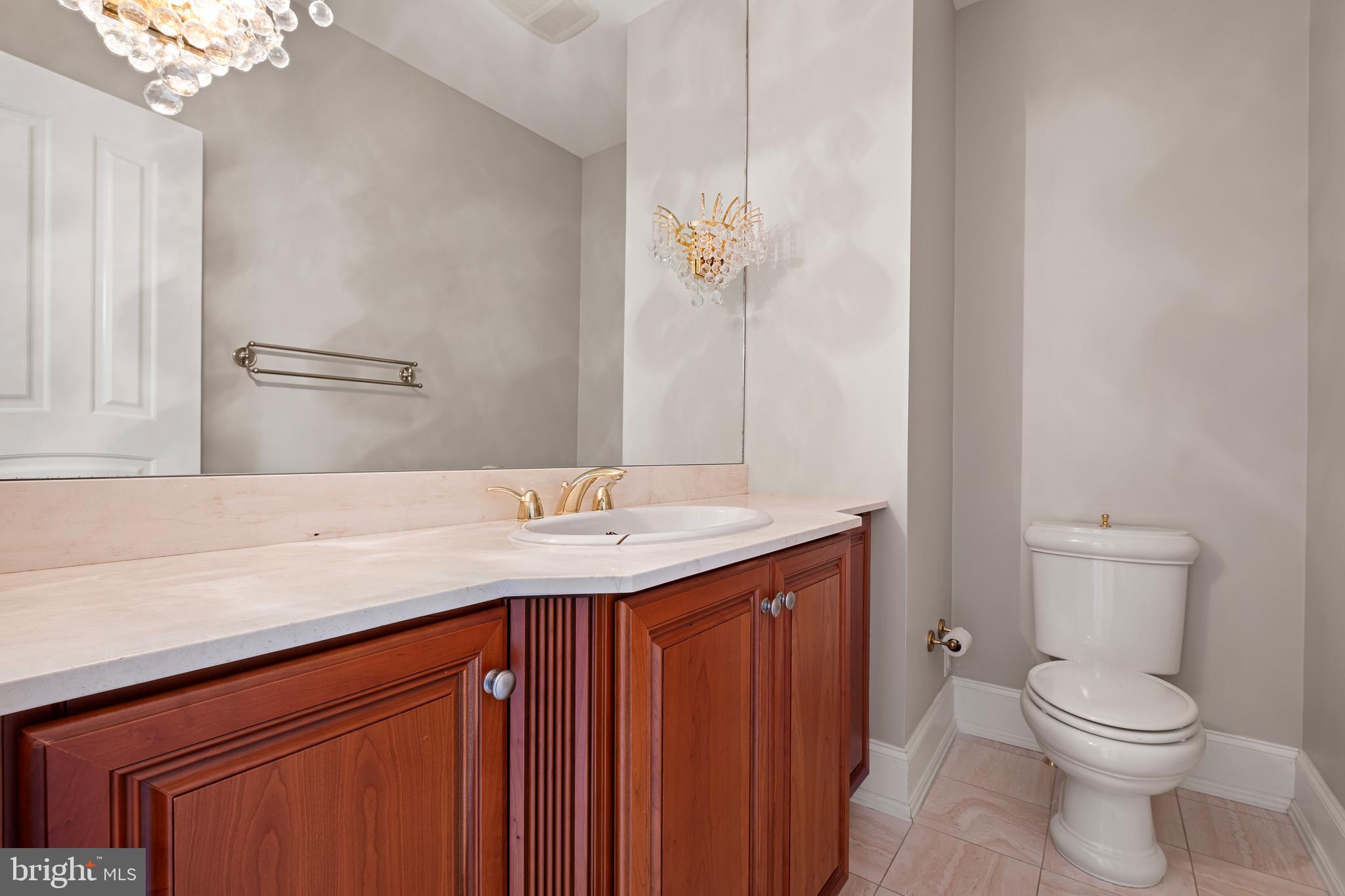 104 Indian Springs Road Kennett Square, PA 19348 - Photo 46 of 106 a bathroom with a granite countertop sink a toilet and a mirror