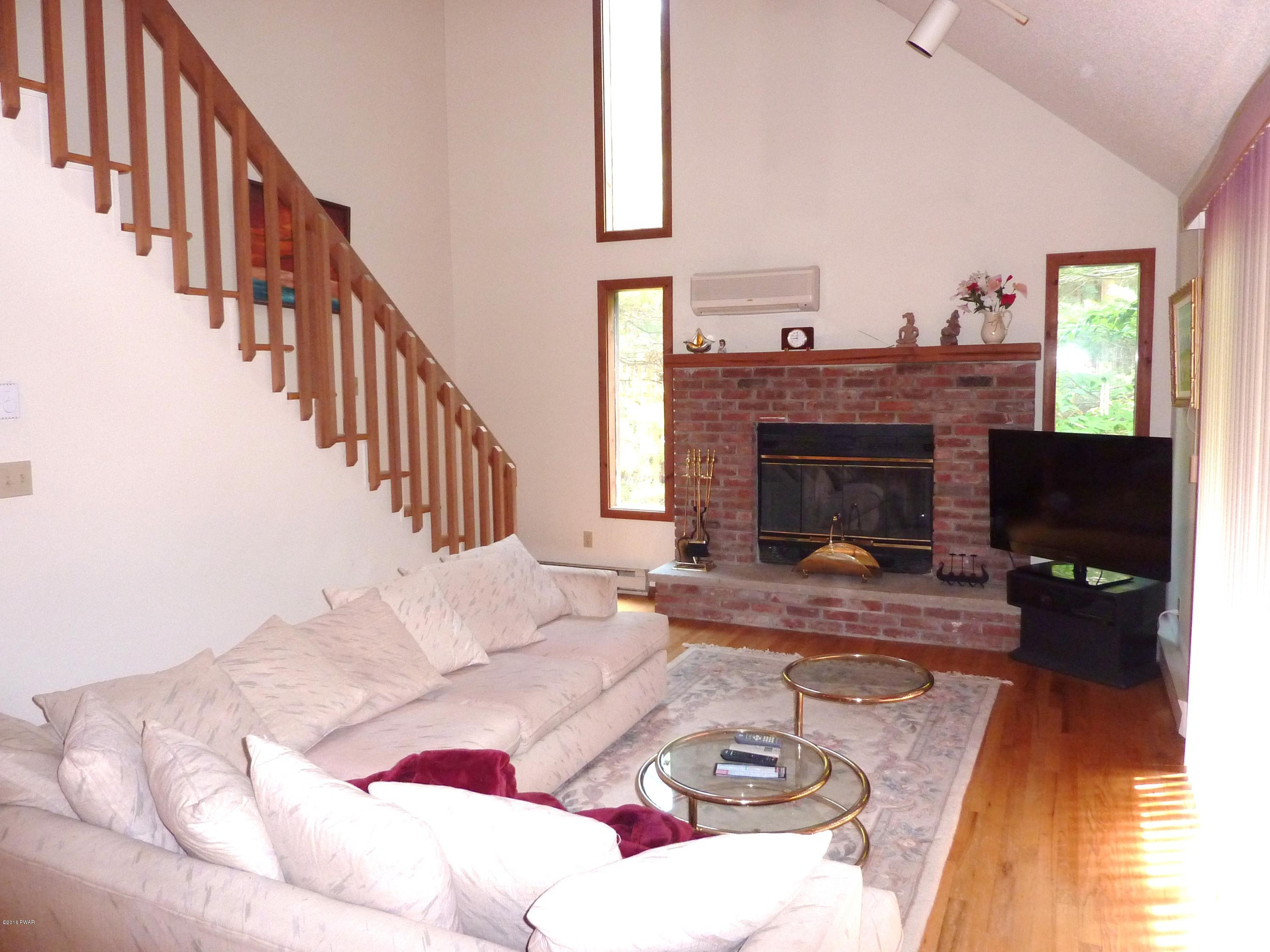 106 Valley Run Road Greentown, PA 18426 - Photo 4 of 21 a living room with furniture a fireplace and a flat screen tv