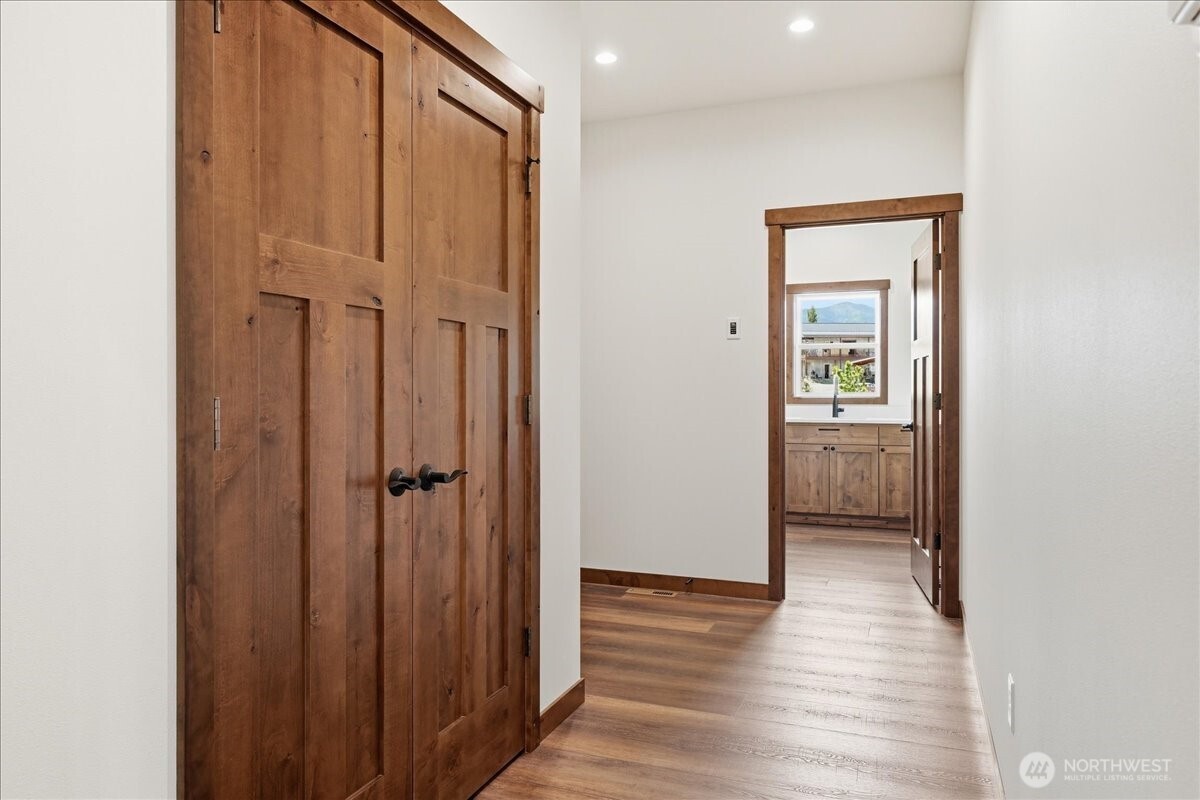 110 Slide View Lane Manson, WA 98831 - Photo 19 of 38 a view of a hallway with wooden floor