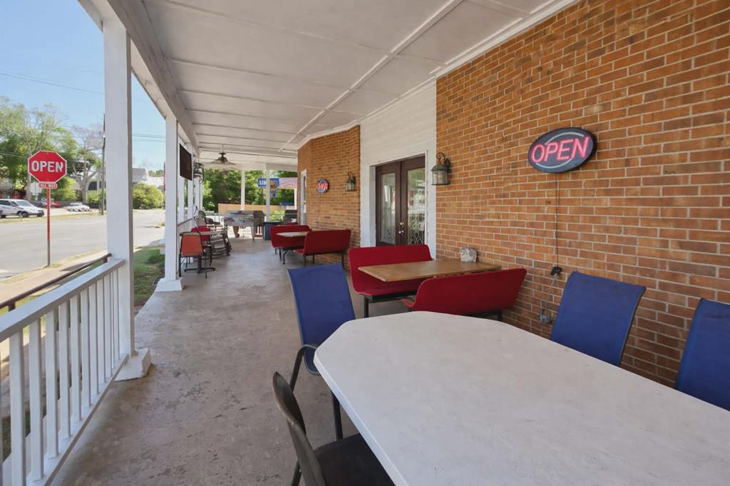 1504 Broad Street Lumpkin, GA 31815 - Photo 3 of 7 a view of a patio with table and chairs potted plants